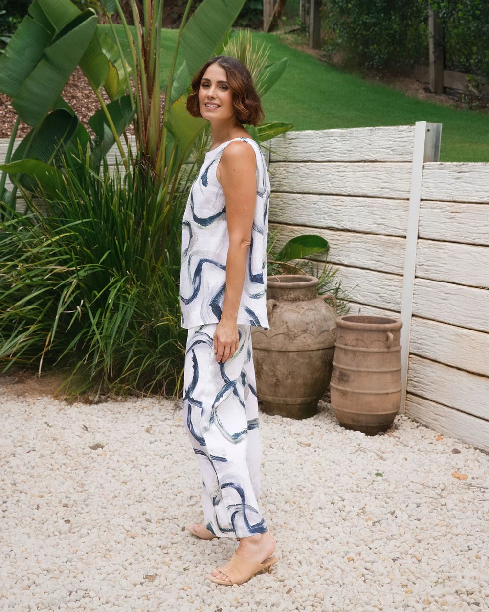 Palazzo linen pants featuring a relaxed wide-leg fit, high waist and shell button detailing down the side seam.