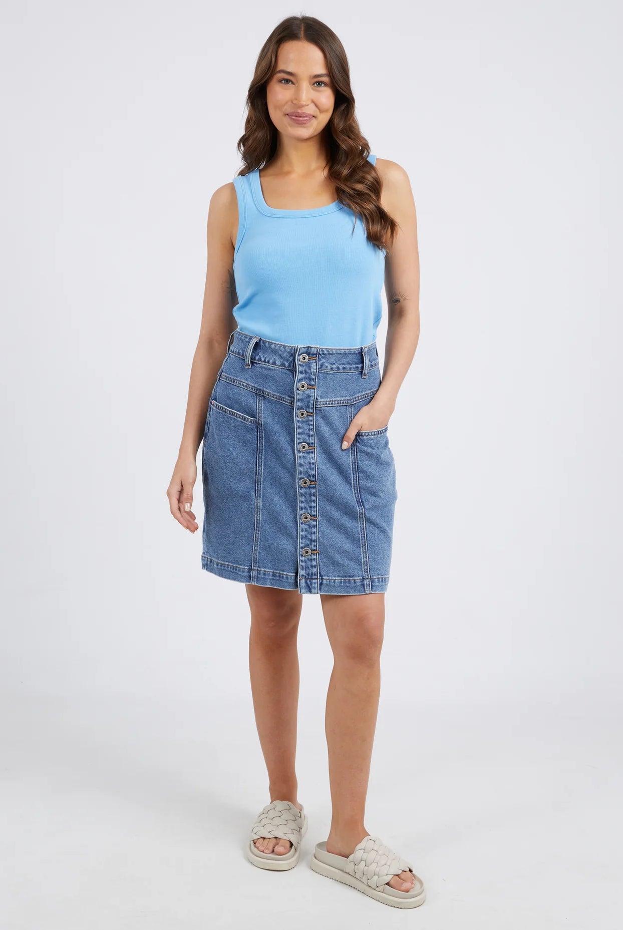 The Blue Eliza Denim Skirt by Elm is currently available at Rawspice Boutique.