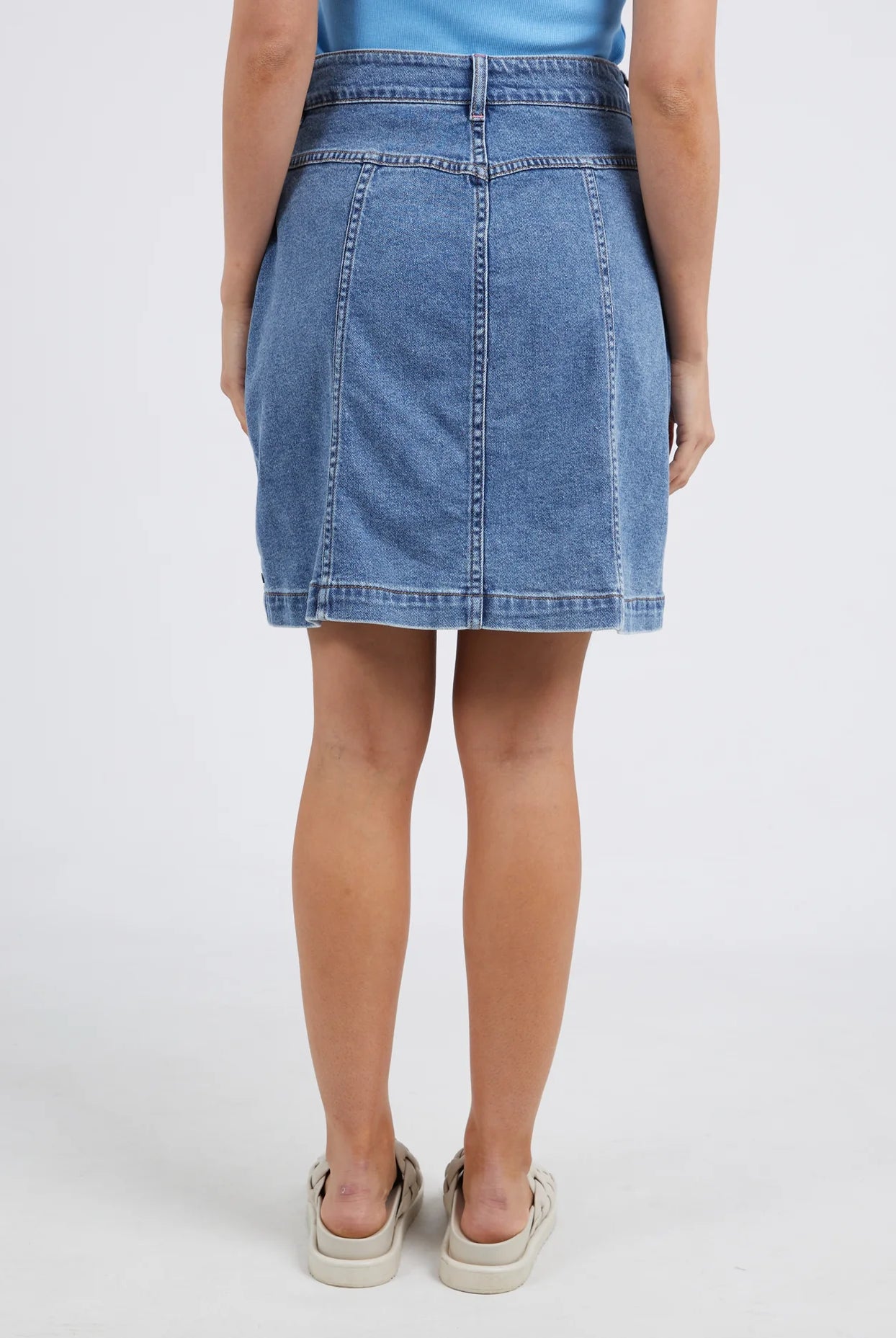 The Blue Eliza Denim Skirt by Elm is currently available at Rawspice Boutique.
