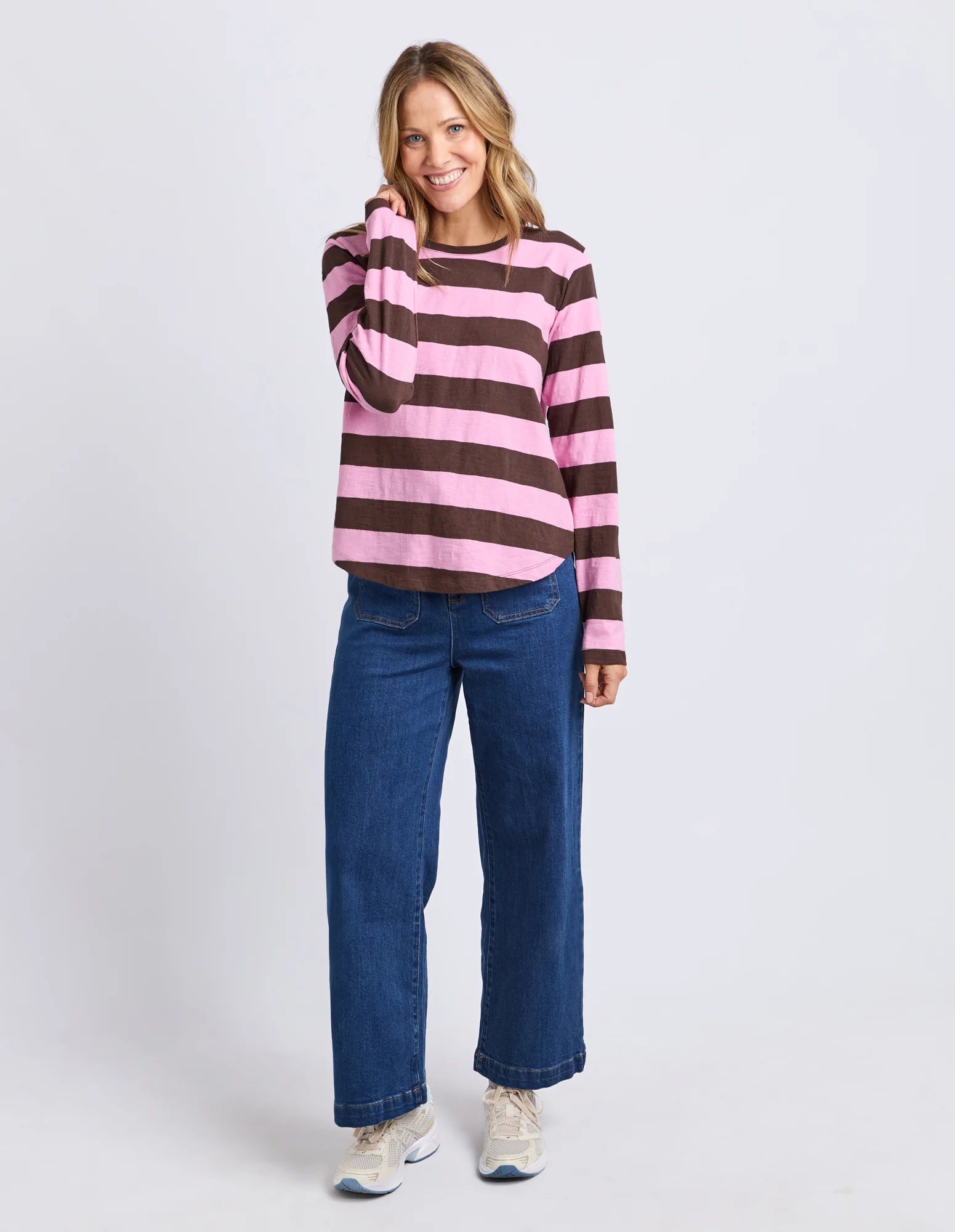 Yarn-dye stripe cotton slub jersey top with a curved hemline, lightweight feel, and relaxed fit ideal for layering.