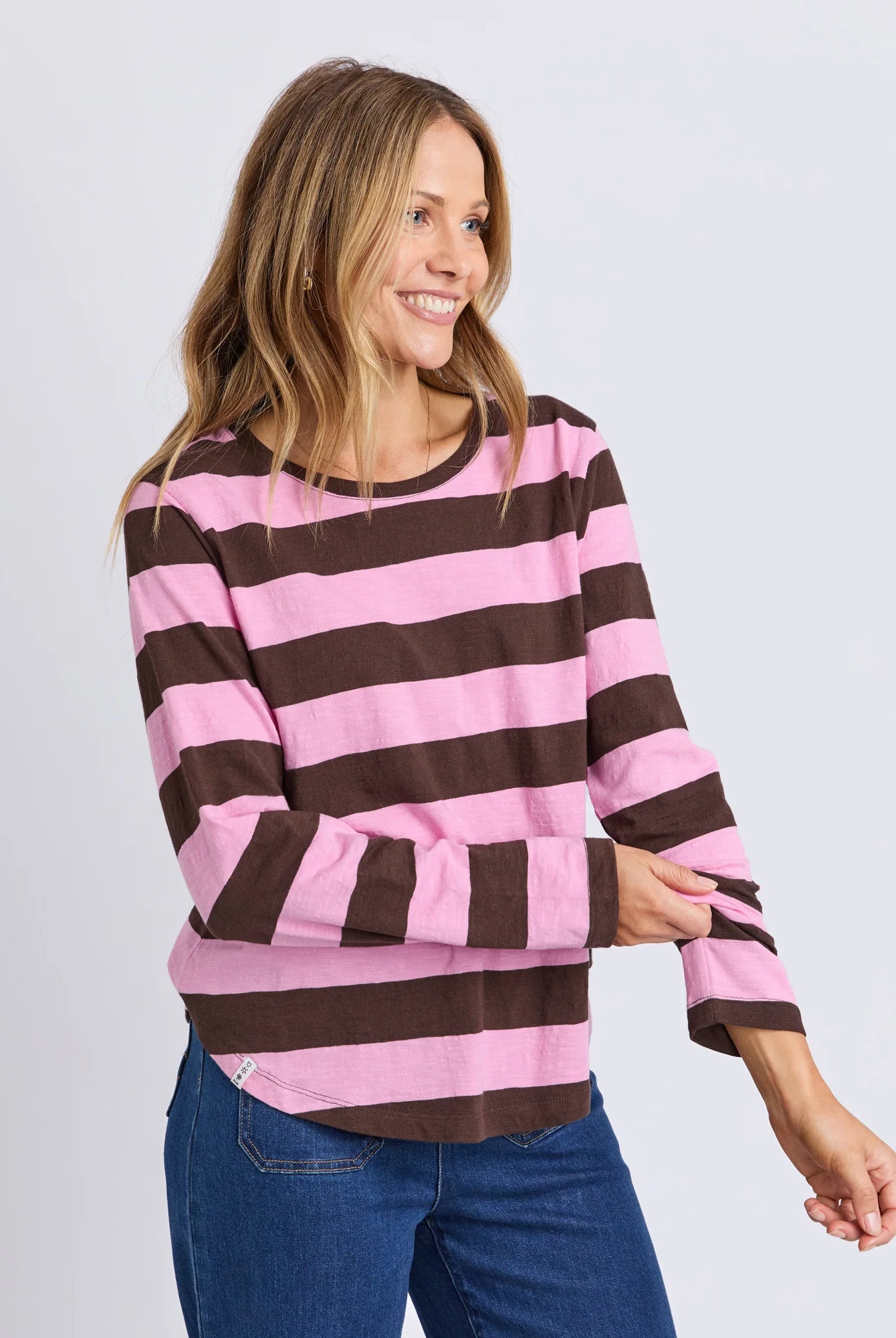 Yarn-dye stripe cotton slub jersey top with a curved hemline, lightweight feel, and relaxed fit ideal for layering.