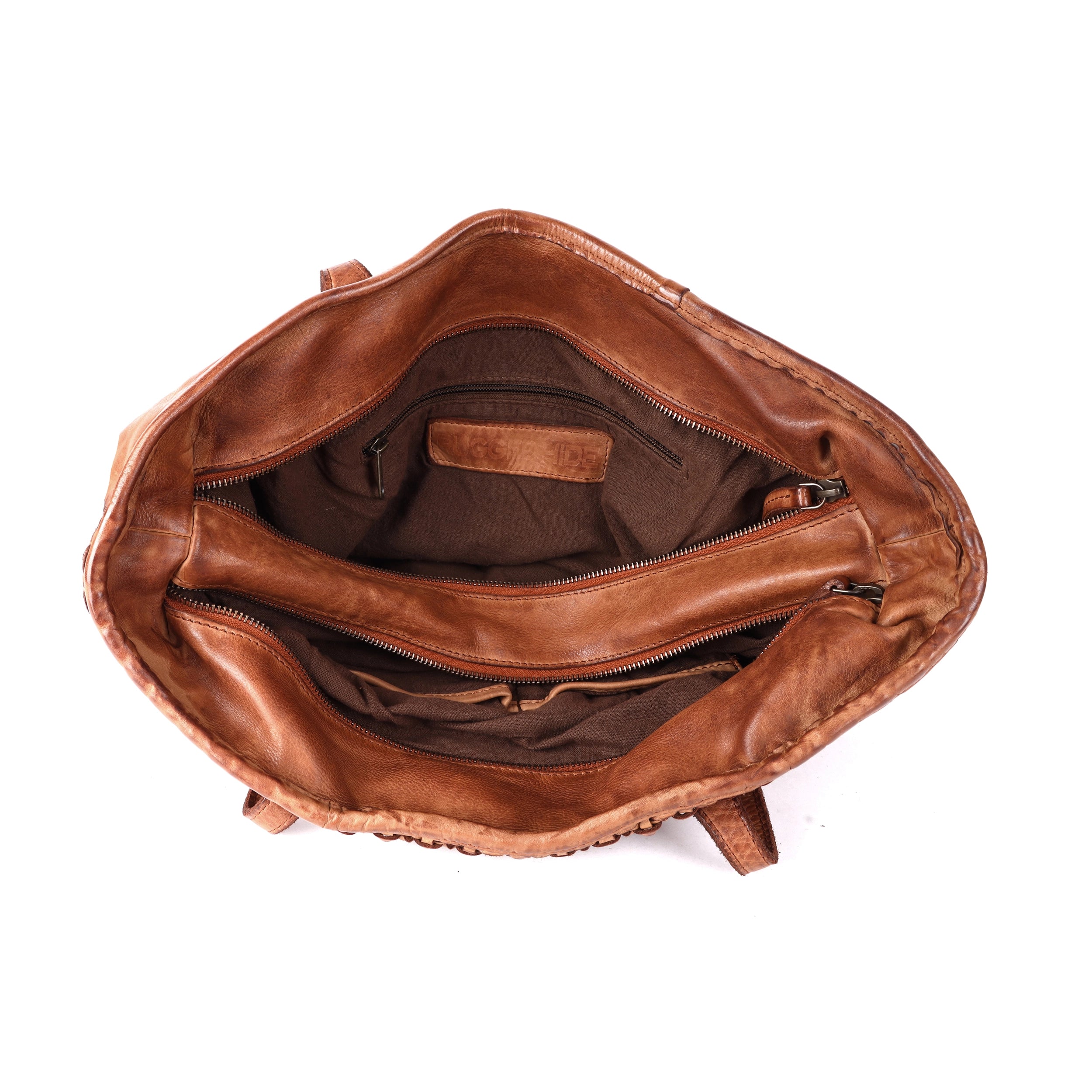 Rugged Hide Kalgoorlie Day Bag, a soft leather shopper with front weave detailing, two zip-secured compartments, internal zip pocket, and sleeve pockets. Measures 33cm x 32cm x 13cm.