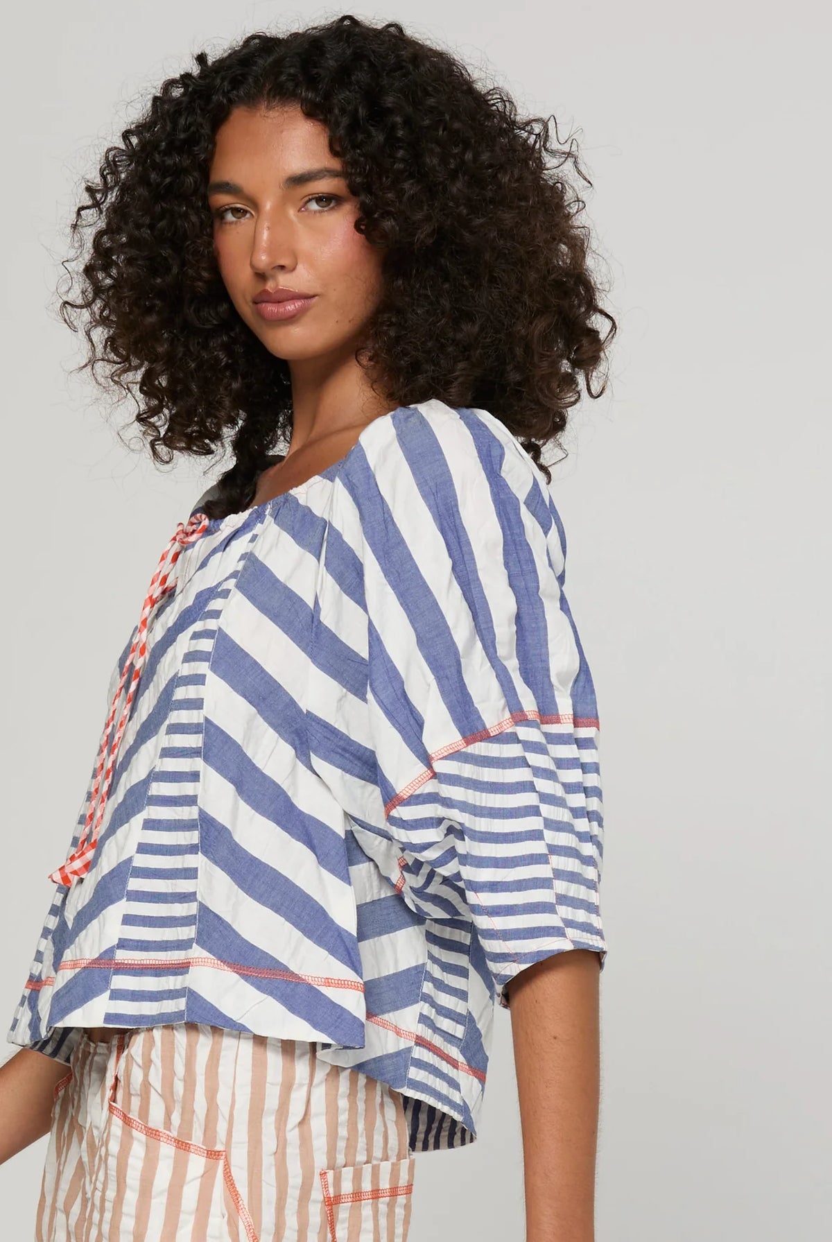 Boom Shankar Lucia Top in Ocean Stripe featuring chevron stripe panelling, balloon sleeves, contrast cuffs and an adjustable tie neckline.