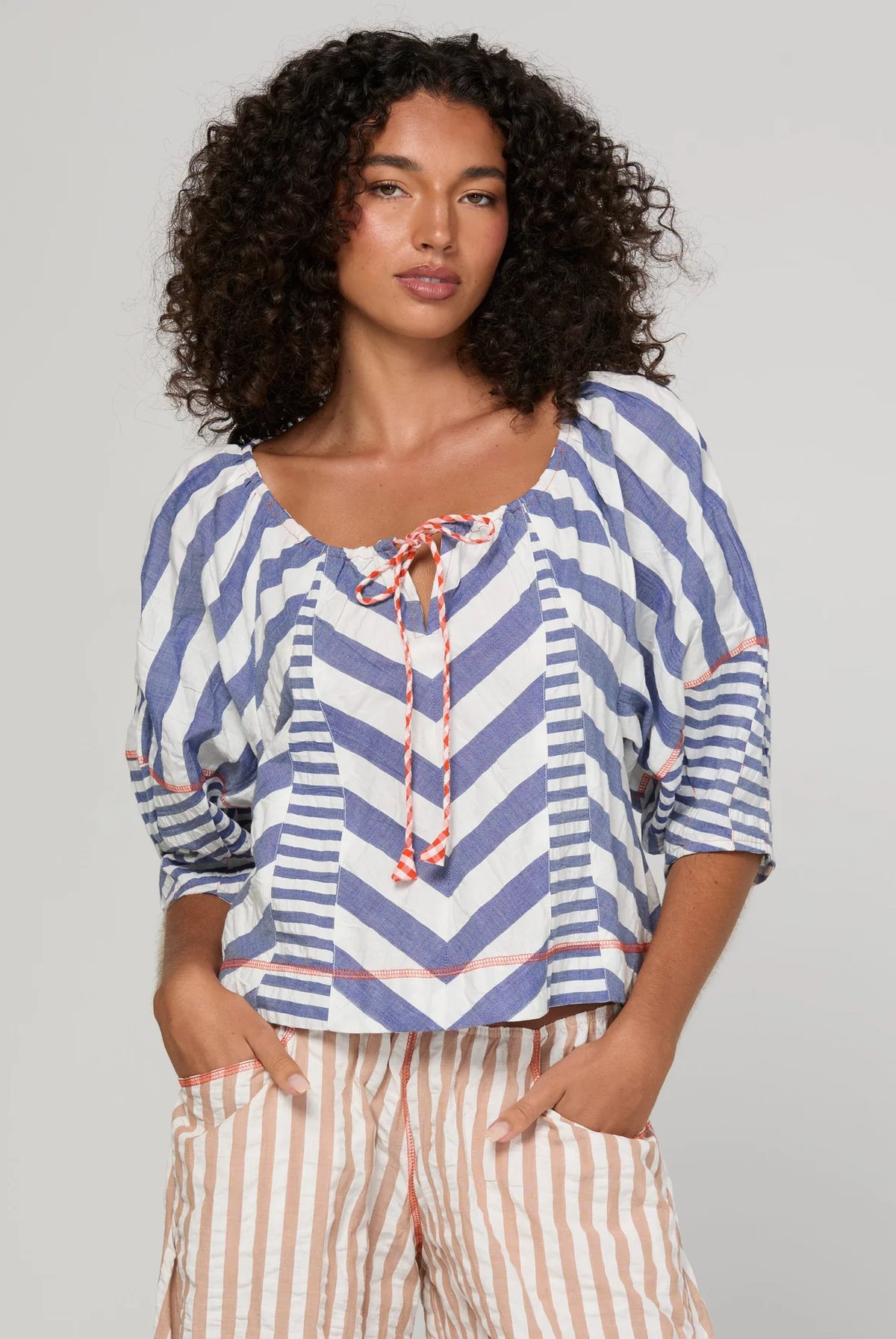 Boom Shankar Lucia Top in Ocean Stripe featuring chevron stripe panelling, balloon sleeves, contrast cuffs and an adjustable tie neckline.
