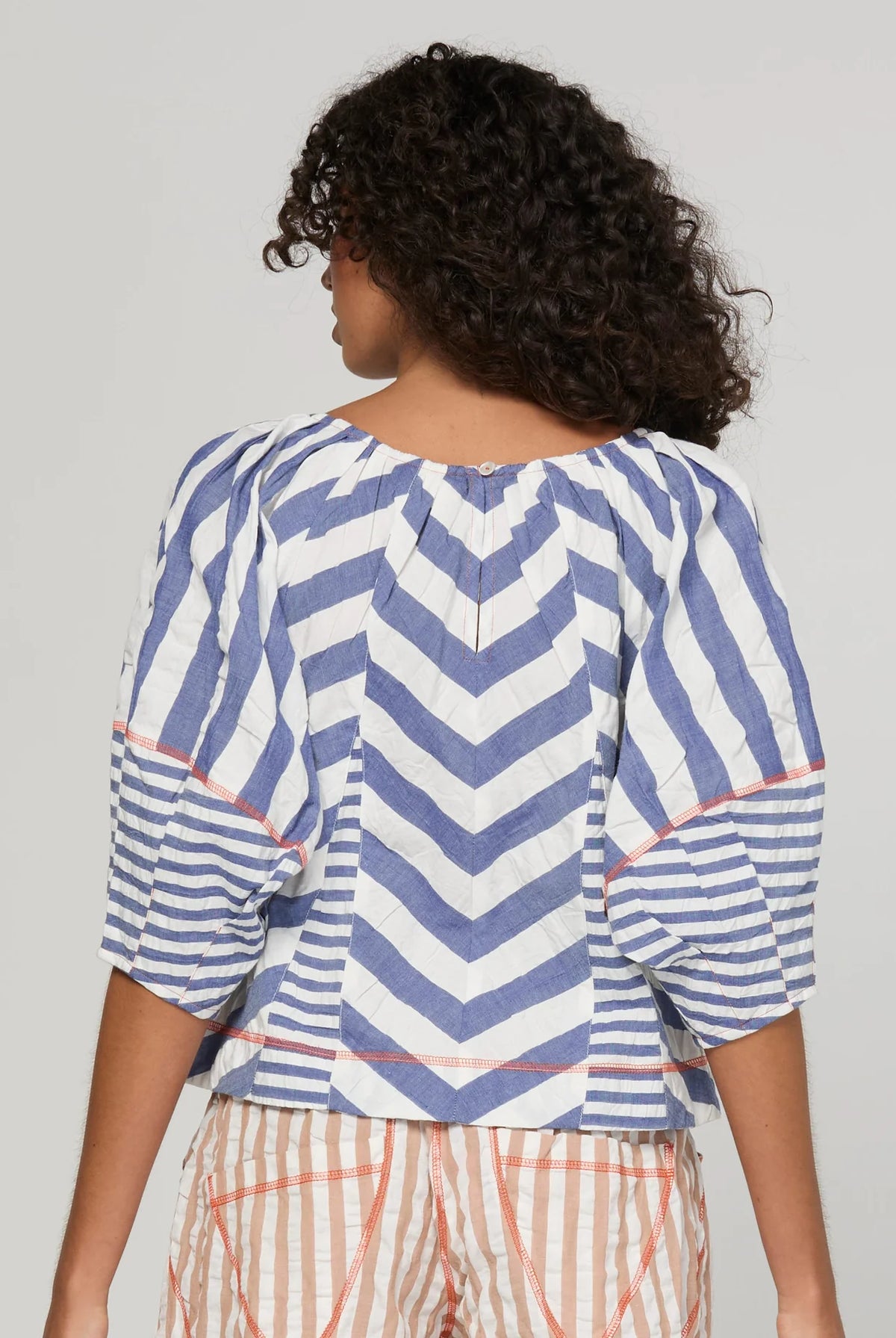 Boom Shankar Lucia Top in Ocean Stripe featuring chevron stripe panelling, balloon sleeves, contrast cuffs and an adjustable tie neckline.