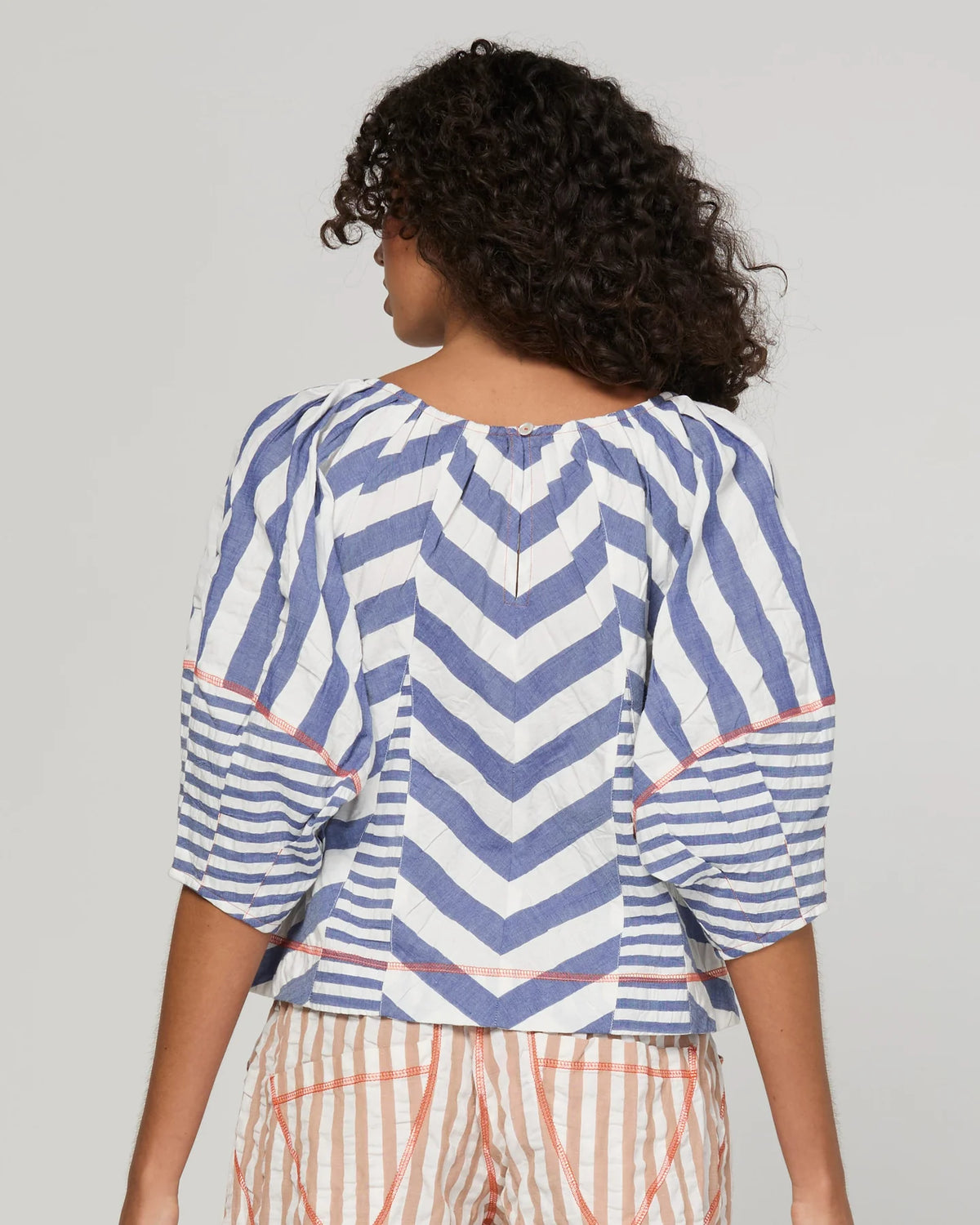 Boom Shankar Lucia Top in Ocean Stripe featuring chevron stripe panelling, balloon sleeves, contrast cuffs and an adjustable tie neckline.