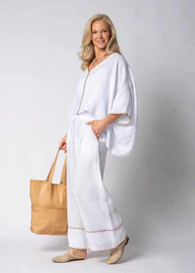 The Mireya Linen Top in White. Relaxed, button-up linen blouse with raw-stitched neckline, styled for warm-weather versatility.