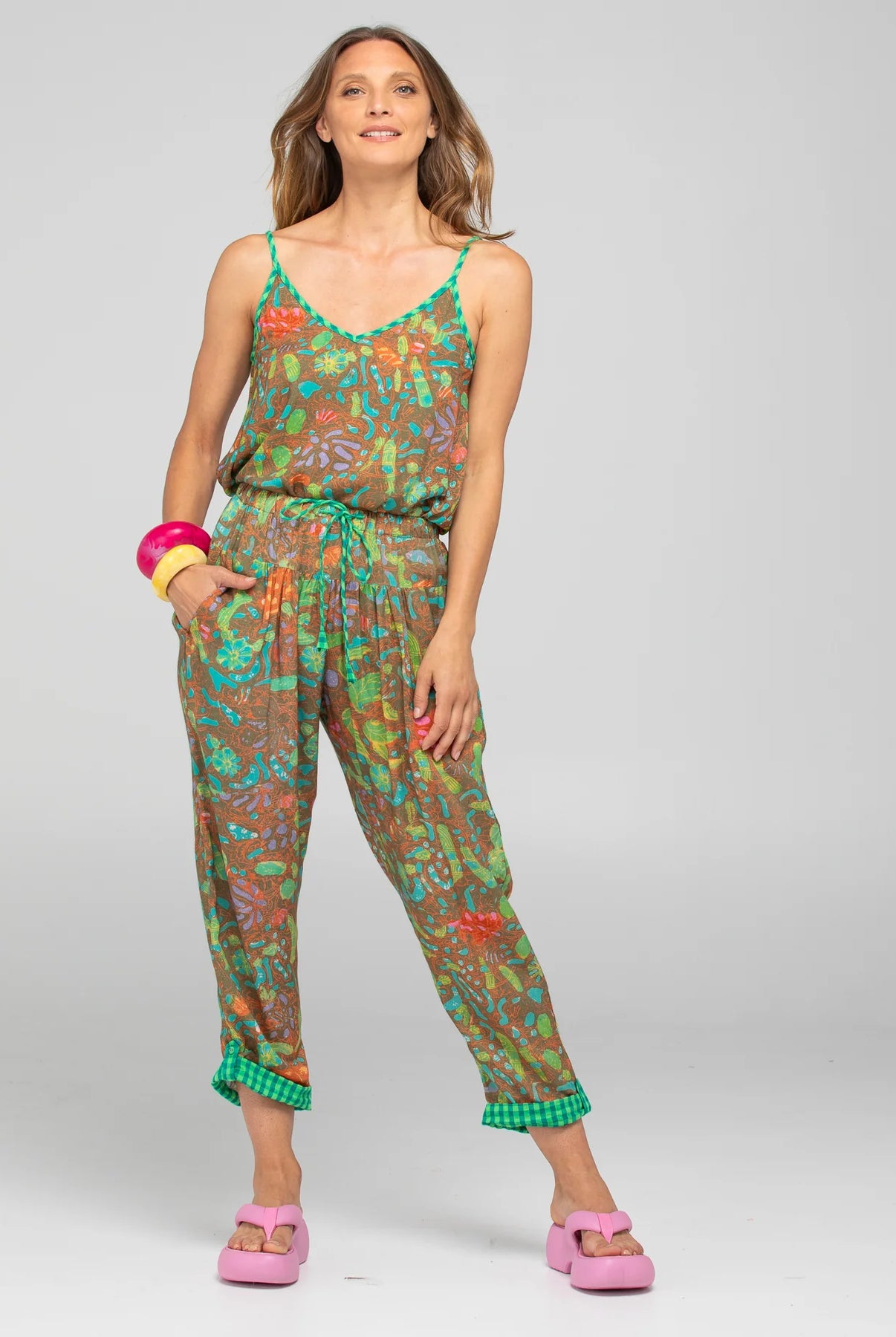Boom Shankar Rimi Pant in vibrant Rimini print, featuring a contrast Verde waist tie, elasticated gathered waistband, side pockets, and cuffed hems with button and tab detailing.
