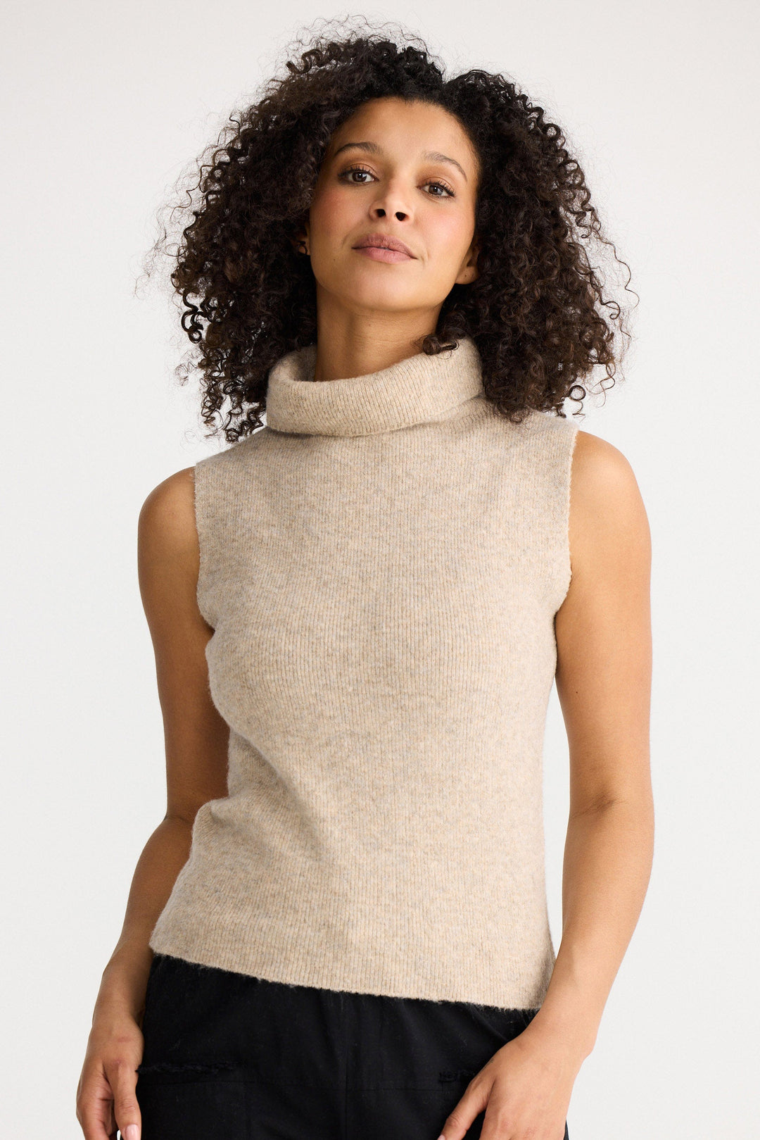 Lucerne Knit Top in oatmeal featuring a high rolled neckline, sleeveless fitted silhouette, rib knit texture and soft fuzzy finish.