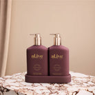 Transformative Duo – Sweet Plum & Berries featuring Wash and Lotion with interchangeable bronze and mulberry pumps, double-sided festive and classic bottles.
