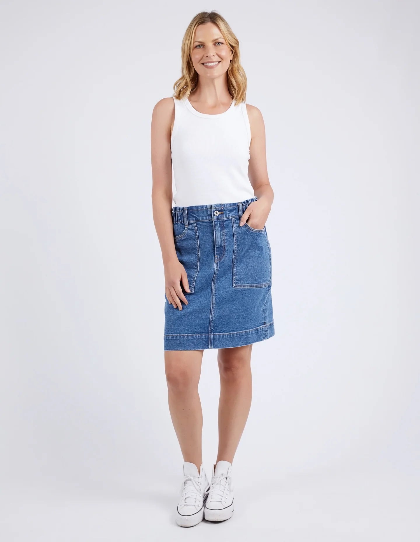 A woman modelling the Atlas Denim Skirt Dark Blue Wash by Elm