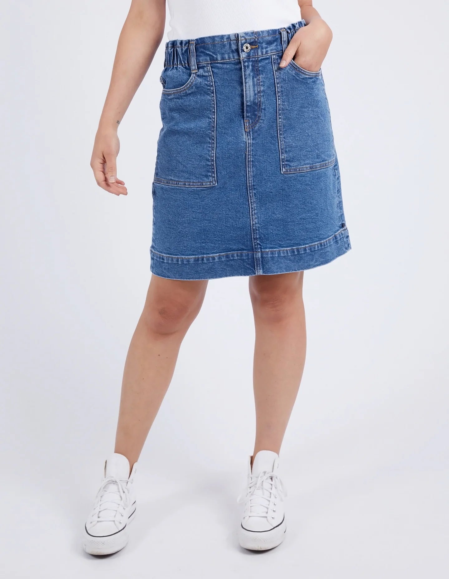 A woman modelling the Atlas Denim Skirt Dark Blue Wash by Elm