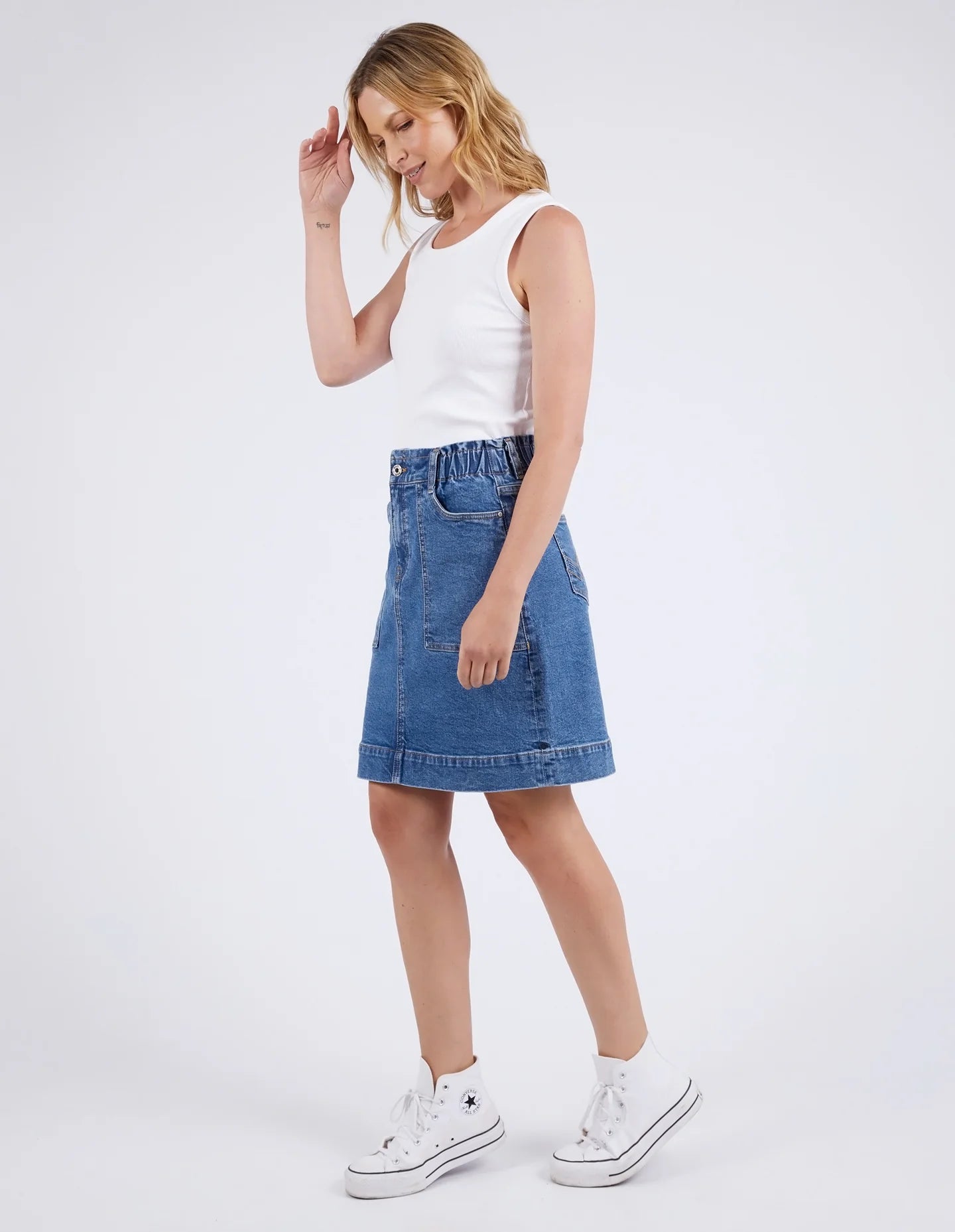 A woman modelling the Atlas Denim Skirt Dark Blue Wash by Elm