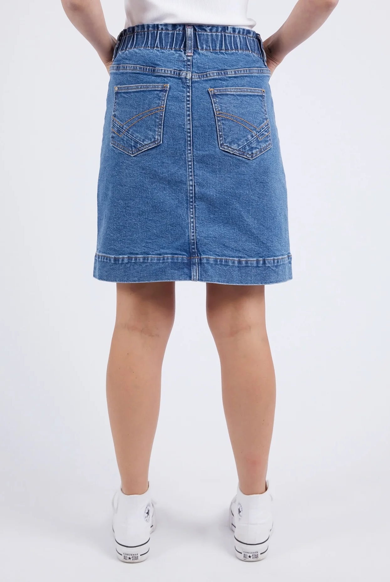 A woman modelling the Atlas Denim Skirt Dark Blue Wash by Elm