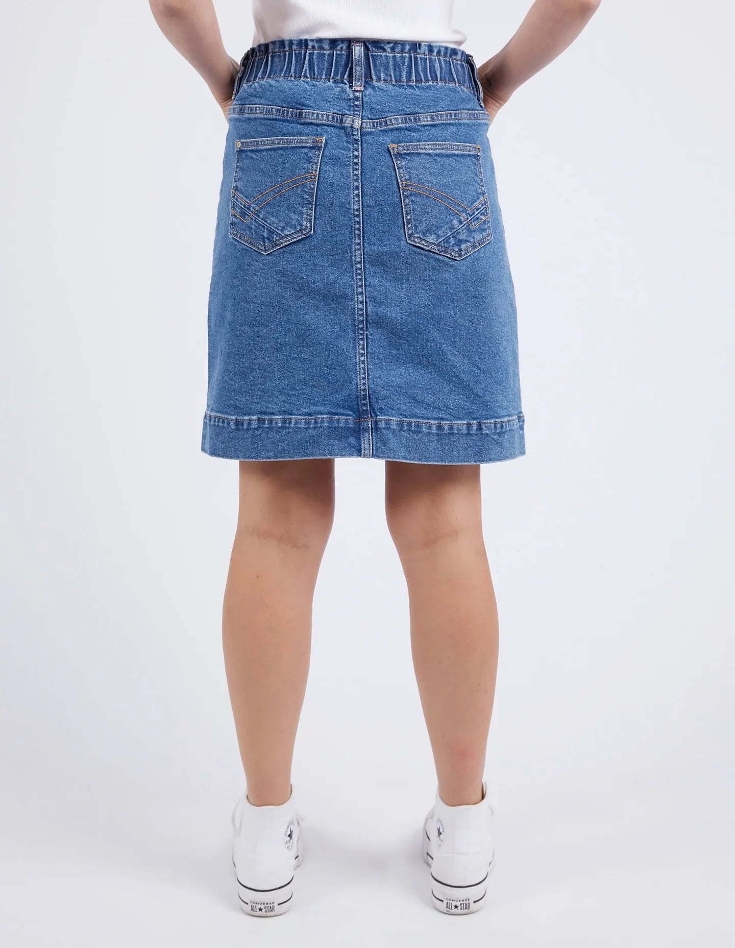 A woman modelling the Atlas Denim Skirt Dark Blue Wash by Elm