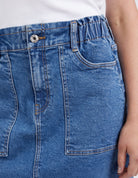 A woman modelling the Atlas Denim Skirt Dark Blue Wash by Elm
