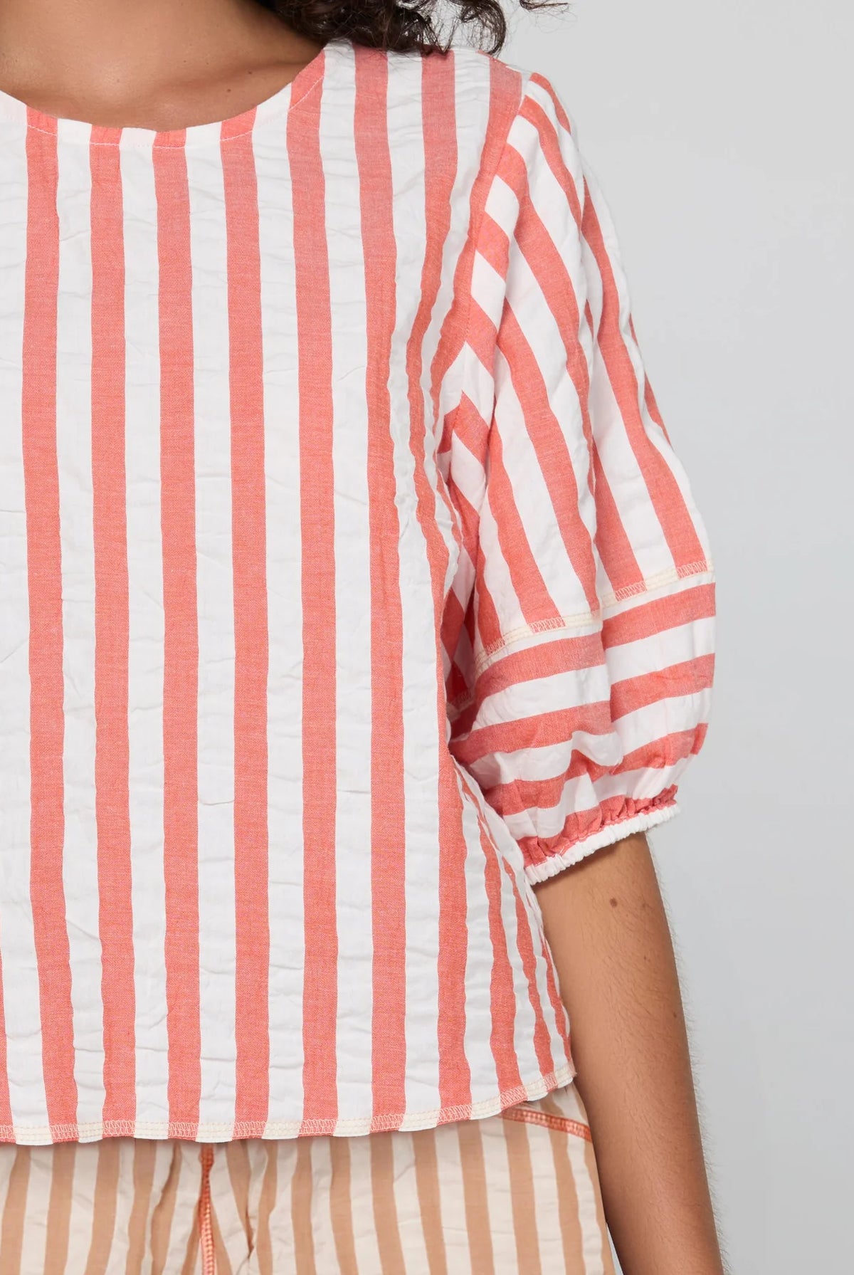 Boom Shankar Ava Top in Watermelon Stripe featuring coral and white stripes, elbow-length puff sleeves, a round neckline and cropped length.