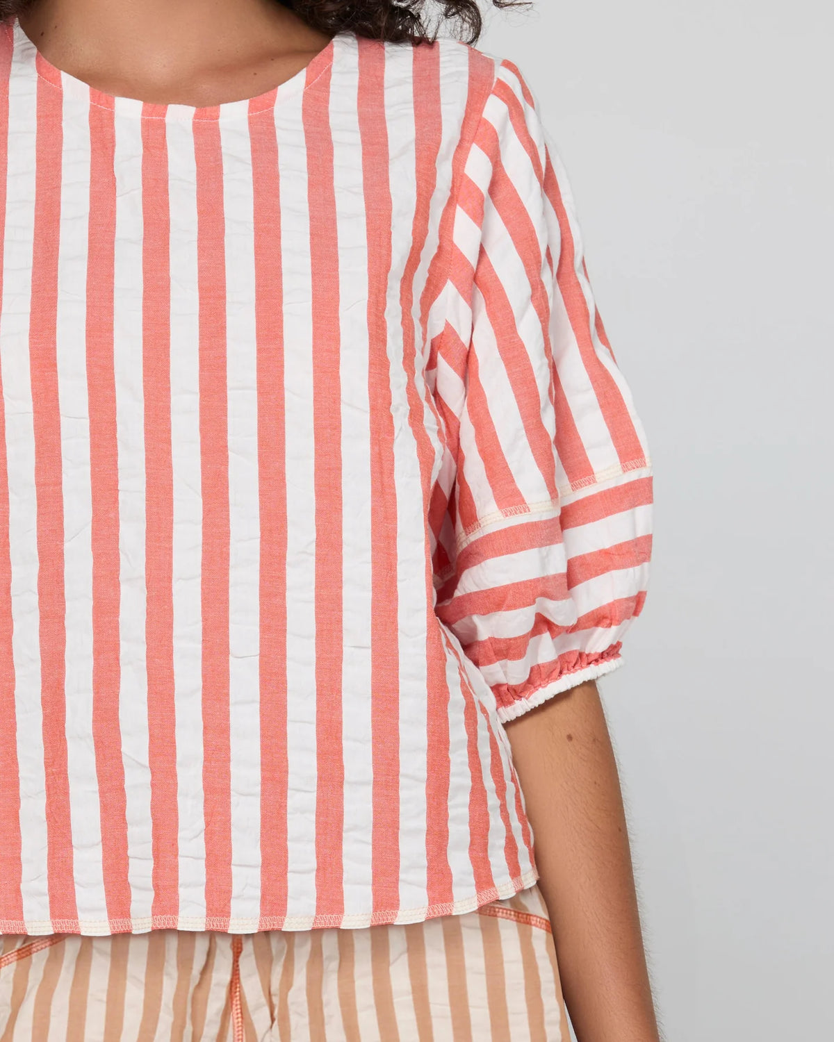 Boom Shankar Ava Top in Watermelon Stripe featuring coral and white stripes, elbow-length puff sleeves, a round neckline and cropped length.