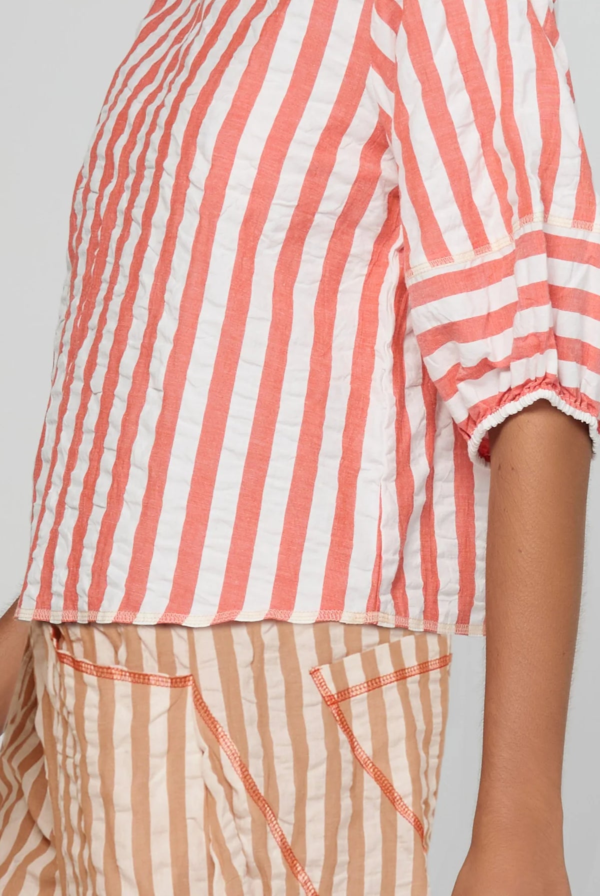 Boom Shankar Ava Top in Watermelon Stripe featuring coral and white stripes, elbow-length puff sleeves, a round neckline and cropped length.