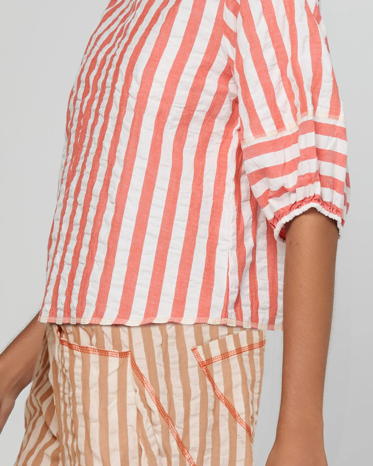 Boom Shankar Ava Top in Watermelon Stripe featuring coral and white stripes, elbow-length puff sleeves, a round neckline and cropped length.