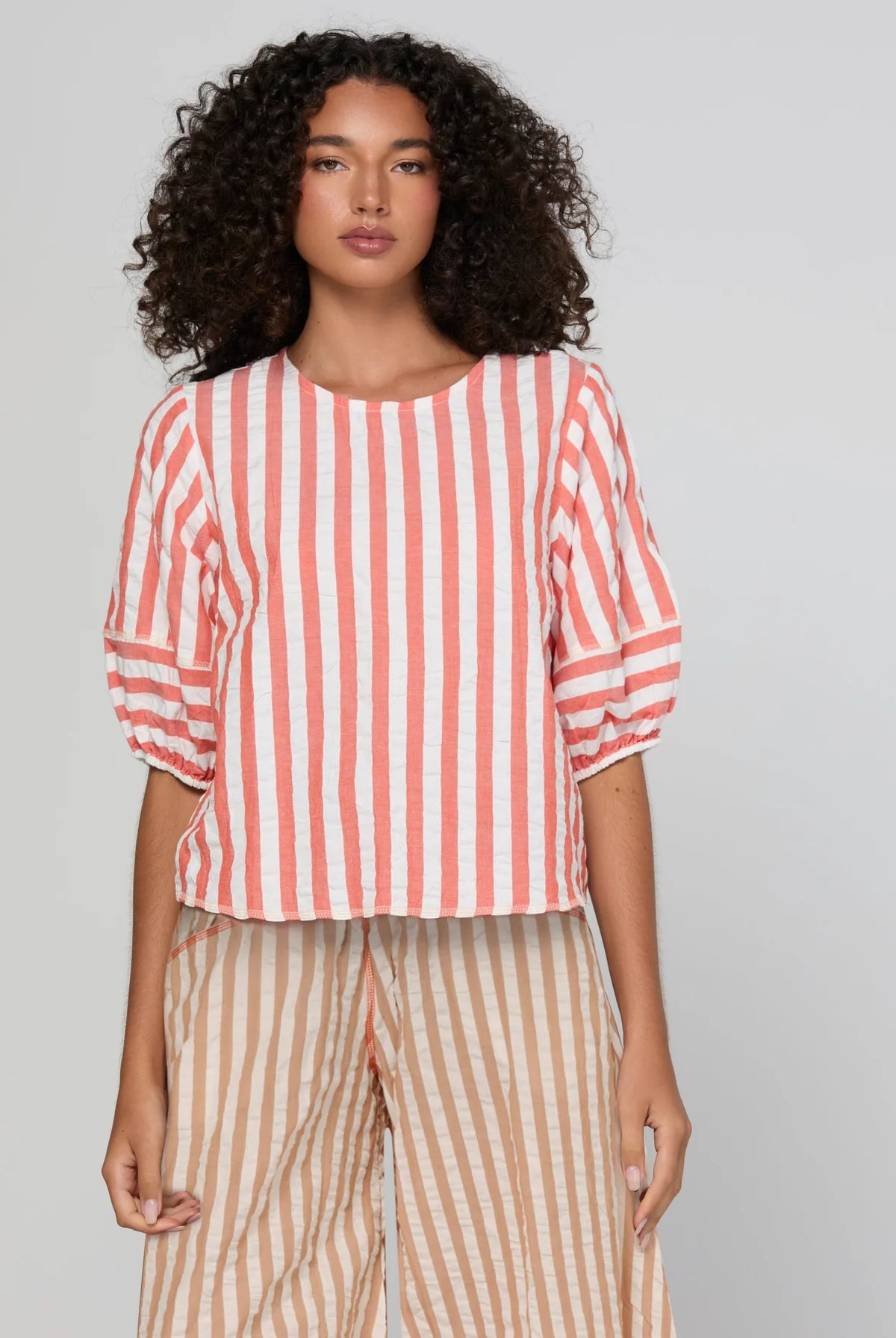 Boom Shankar Ava Top in Watermelon Stripe featuring coral and white stripes, elbow-length puff sleeves, a round neckline and cropped length.