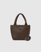 A stylish woven tote bag with top handles and an adjustable crossbody strap, perfect for effortless everyday elegance and versatility.