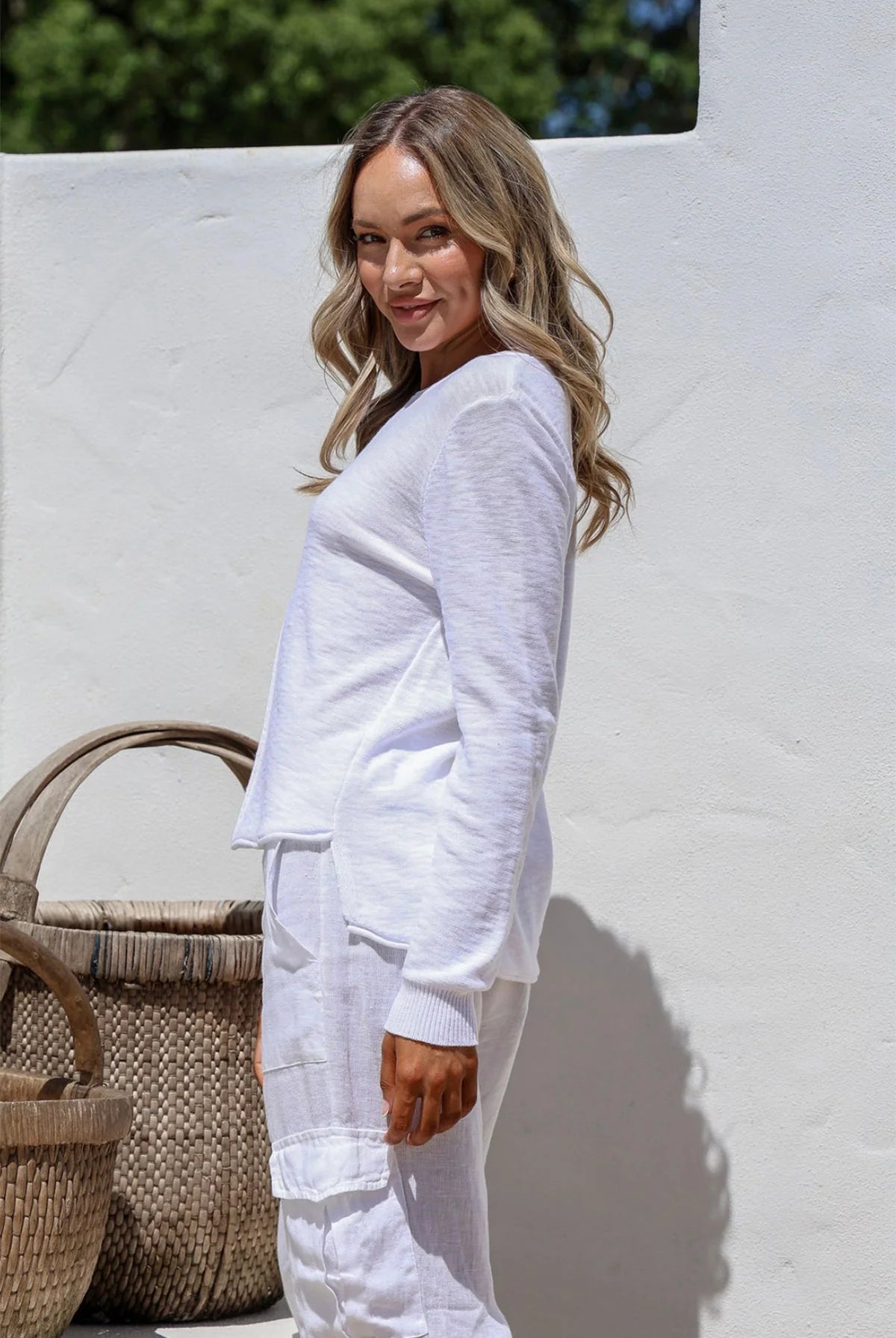 White 100% cotton light knit top with a breathable, timeless design, ideal for layering or wearing alone for everyday comfort and style.