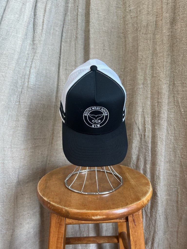Rocks Hat in black featuring a whale tail design on the front, snapback closure, and breathable mesh sides for a comfortable, adjustable fit.