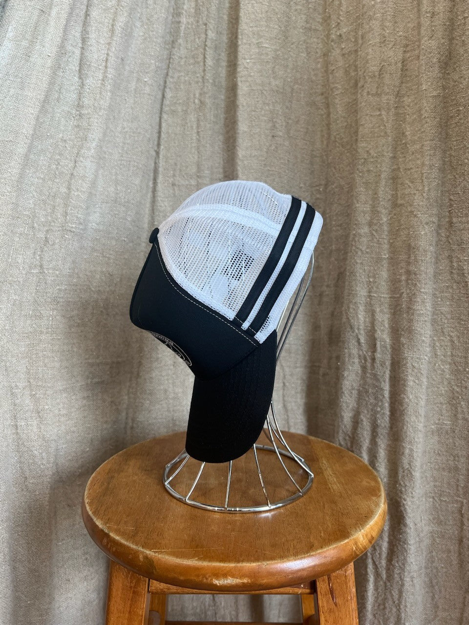 Rocks Hat in black featuring a whale tail design on the front, snapback closure, and breathable mesh sides for a comfortable, adjustable fit.