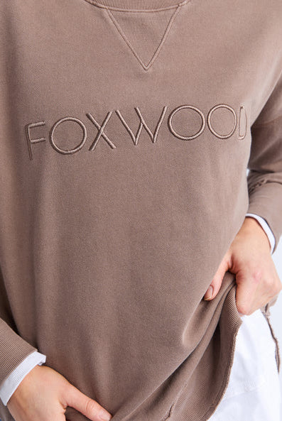 Foxwood Simplified Crew in chocolate brown with round neck, raw edge details, and side splits for a relaxed, everyday look.