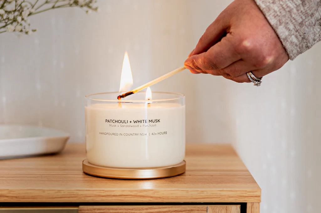 Meeraboo Gold Lid Soy Candle in a clear glass vessel with a brushed gold lid and double wicks, hand-poured with soy wax for long-lasting fragrance.