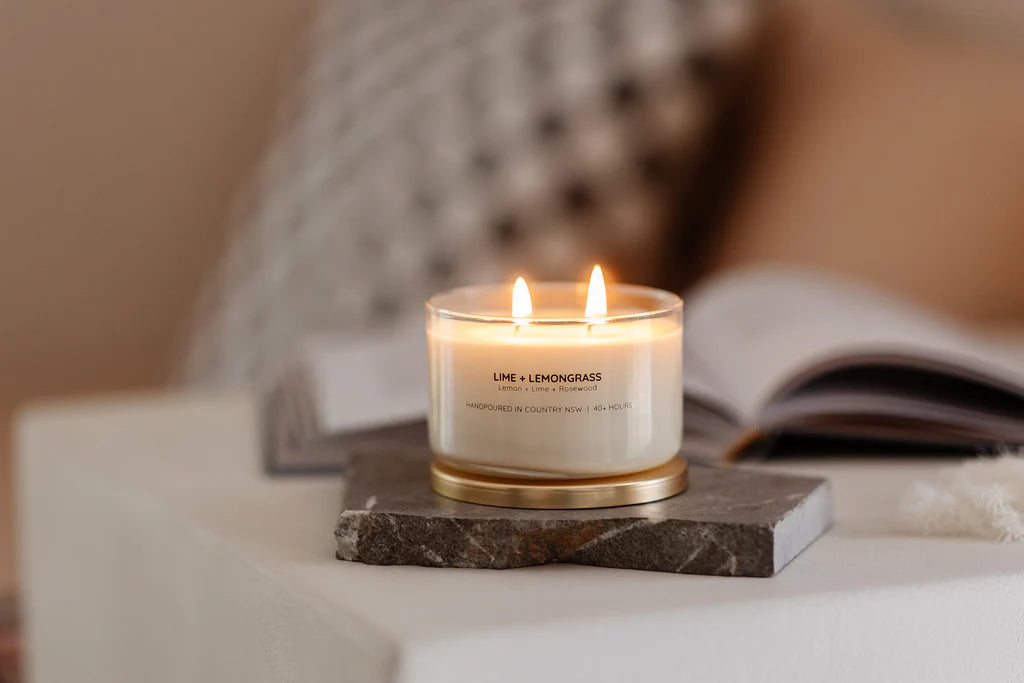 Meeraboo Gold Lid Soy Candle in a clear glass vessel with a brushed gold lid and double wicks, hand-poured with soy wax for long-lasting fragrance.