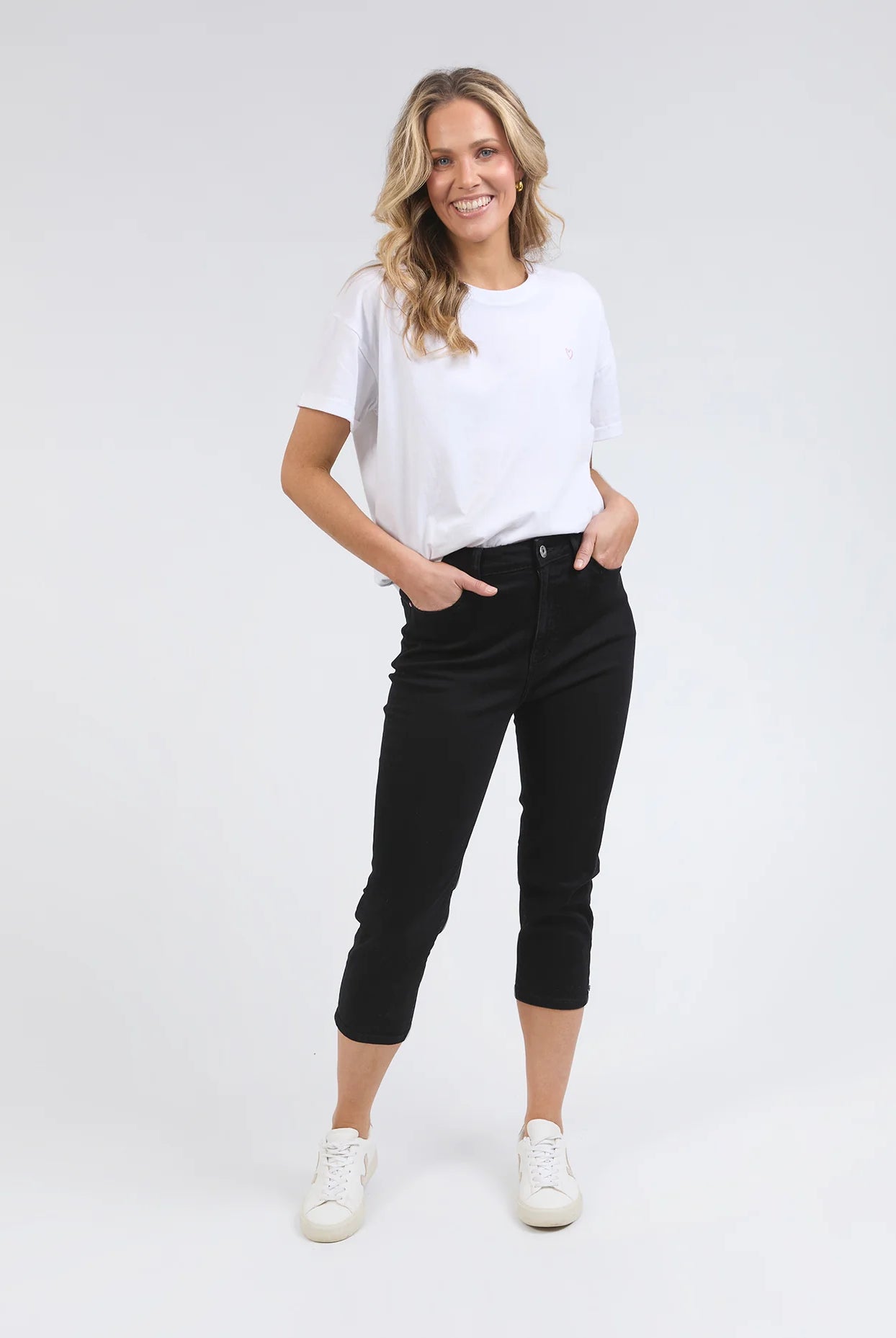 Black Mollie Capri Jeans featuring a slim, cropped leg for a flattering fit. Made from soft stretch denim with a classic 5-pocket design, calf-length cut, and Elm-stamped hardware. The comfortable button-and-fly fastening makes them a practical choice for effortless style. Crafted from 78% cotton, 20% polyester, and 2% elastane for a perfect balance of comfort and flexibility.