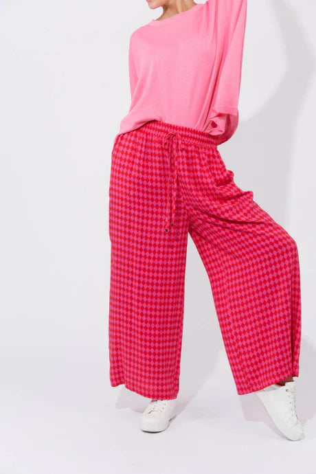 Casablanca Pants in Chilli/Pink featuring a high-rise fit, elastic waist with drawstring, inseam pockets, wide straight leg, and ankle-length cut.