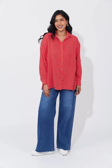 Vanuatu Shirt in Chilli with a relaxed fit, subtle square print, curved hem, and rolled tab sleeves showing a contrast colour block.