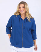 Blue waffle-textured zip-up hoodie with 3/4 length sleeves, a relaxed drop-shoulder fit, and a slightly cropped body for a casual, stylish look.