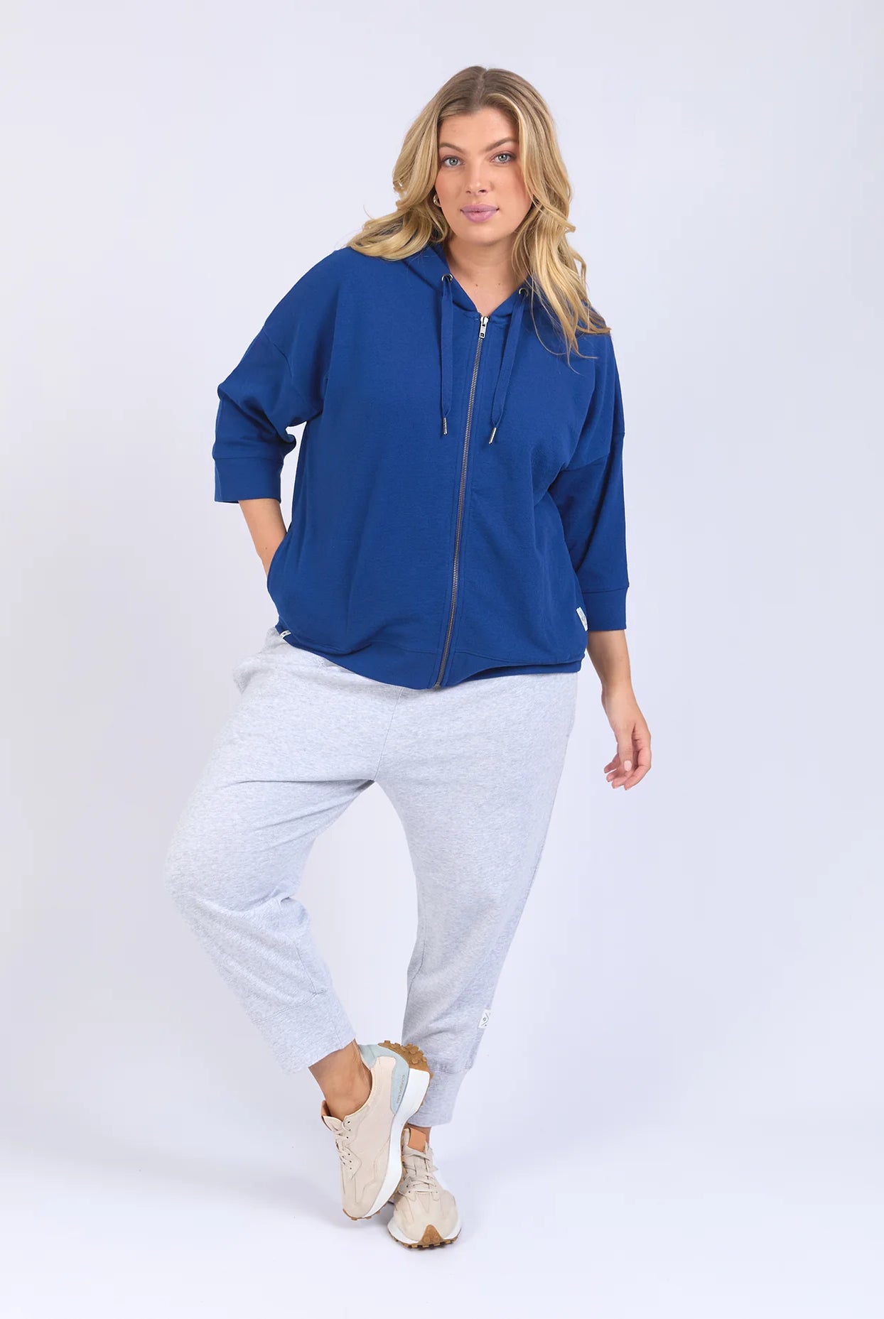 Blue waffle-textured zip-up hoodie with 3/4 length sleeves, a relaxed drop-shoulder fit, and a slightly cropped body for a casual, stylish look.