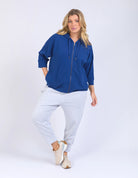 Blue waffle-textured zip-up hoodie with 3/4 length sleeves, a relaxed drop-shoulder fit, and a slightly cropped body for a casual, stylish look.