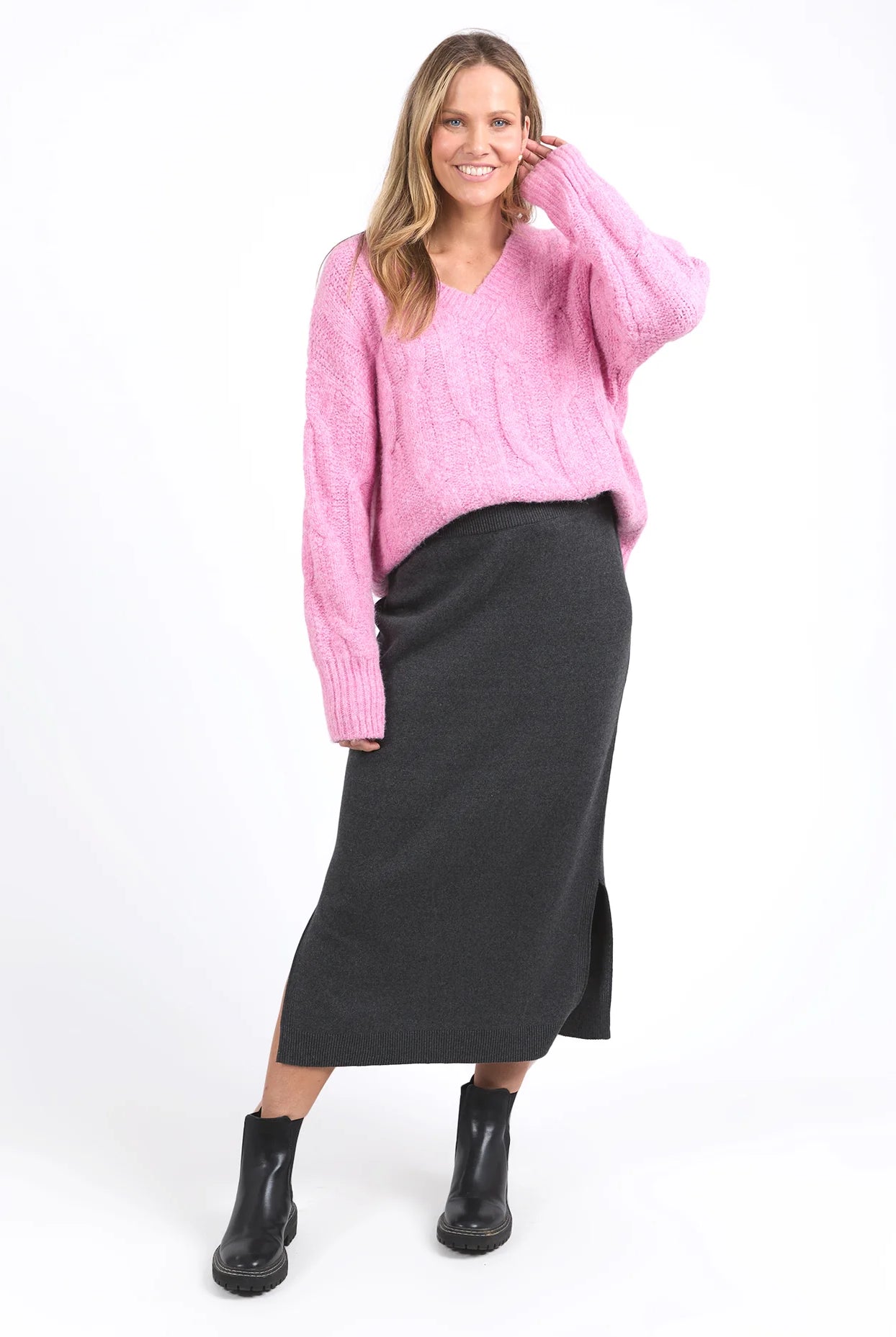 Charcoal marle knit skirt with calf-length cut, side splits, and an elastic waist, offering a flattering and versatile fit for every season.