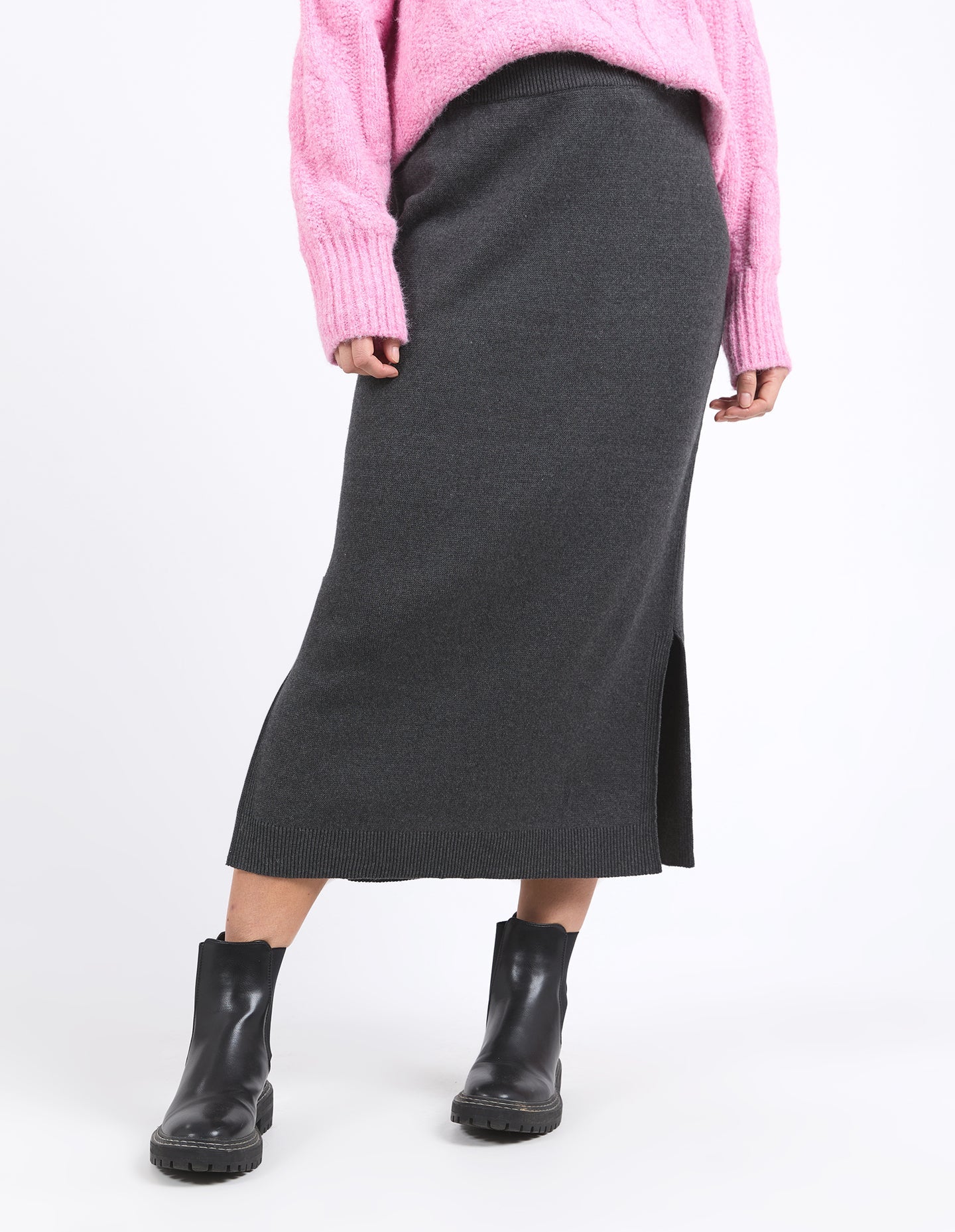 Charcoal marle knit skirt with calf-length cut, side splits, and an elastic waist, offering a flattering and versatile fit for every season.