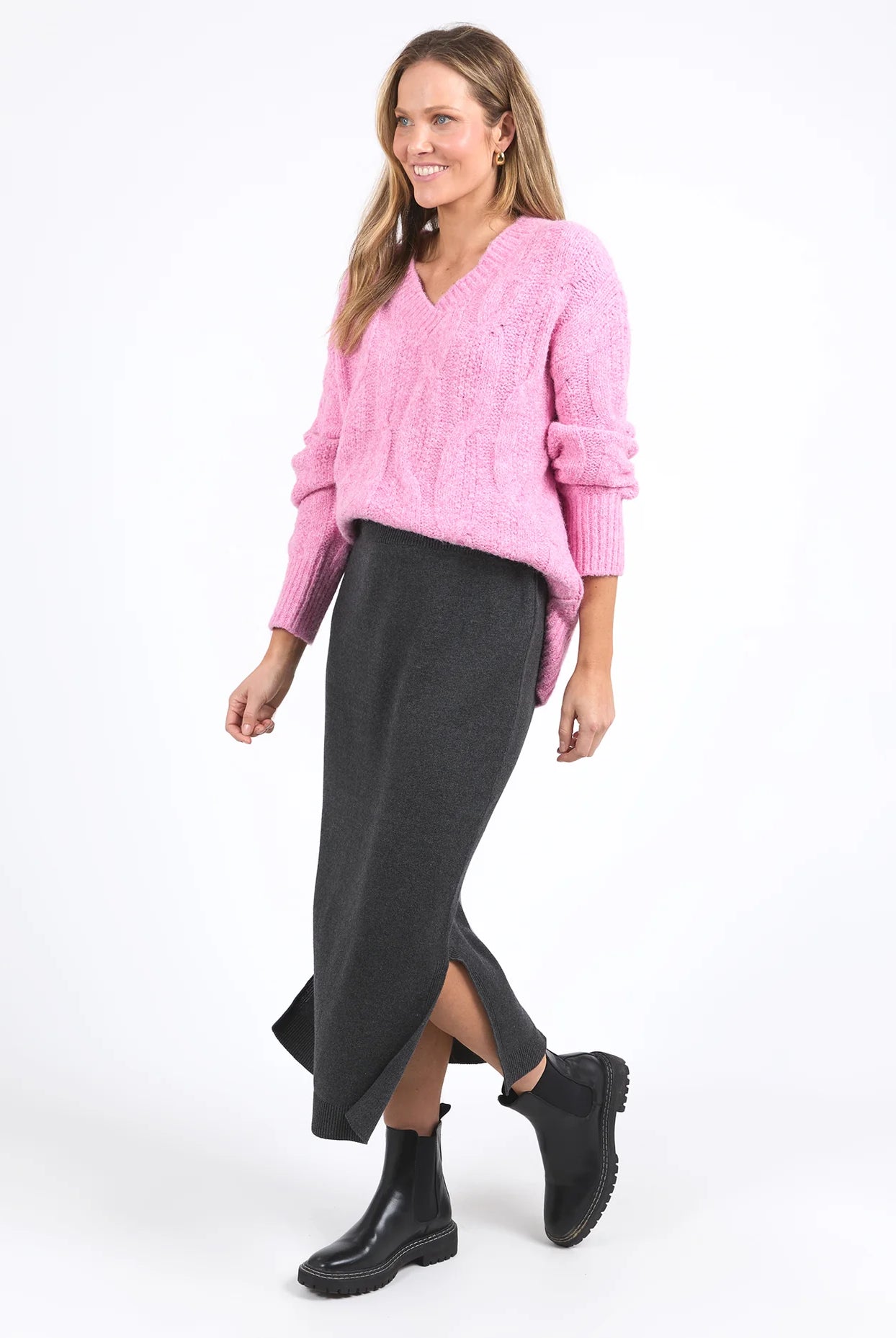 Charcoal marle knit skirt with calf-length cut, side splits, and an elastic waist, offering a flattering and versatile fit for every season.