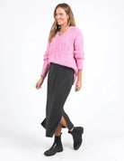 Charcoal marle knit skirt with calf-length cut, side splits, and an elastic waist, offering a flattering and versatile fit for every season.