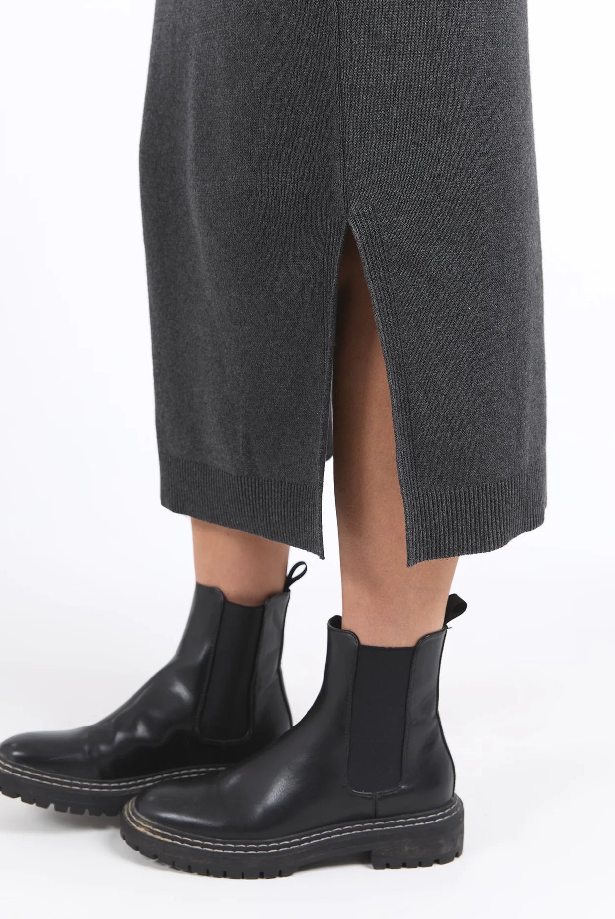 Charcoal marle knit skirt with calf-length cut, side splits, and an elastic waist, offering a flattering and versatile fit for every season.