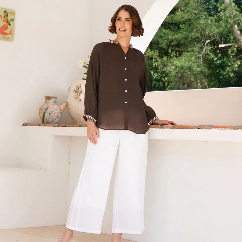 Ramie top featuring an embroidered collar and cuffs, notched neckline, gathered blouson sleeves and button-through front.