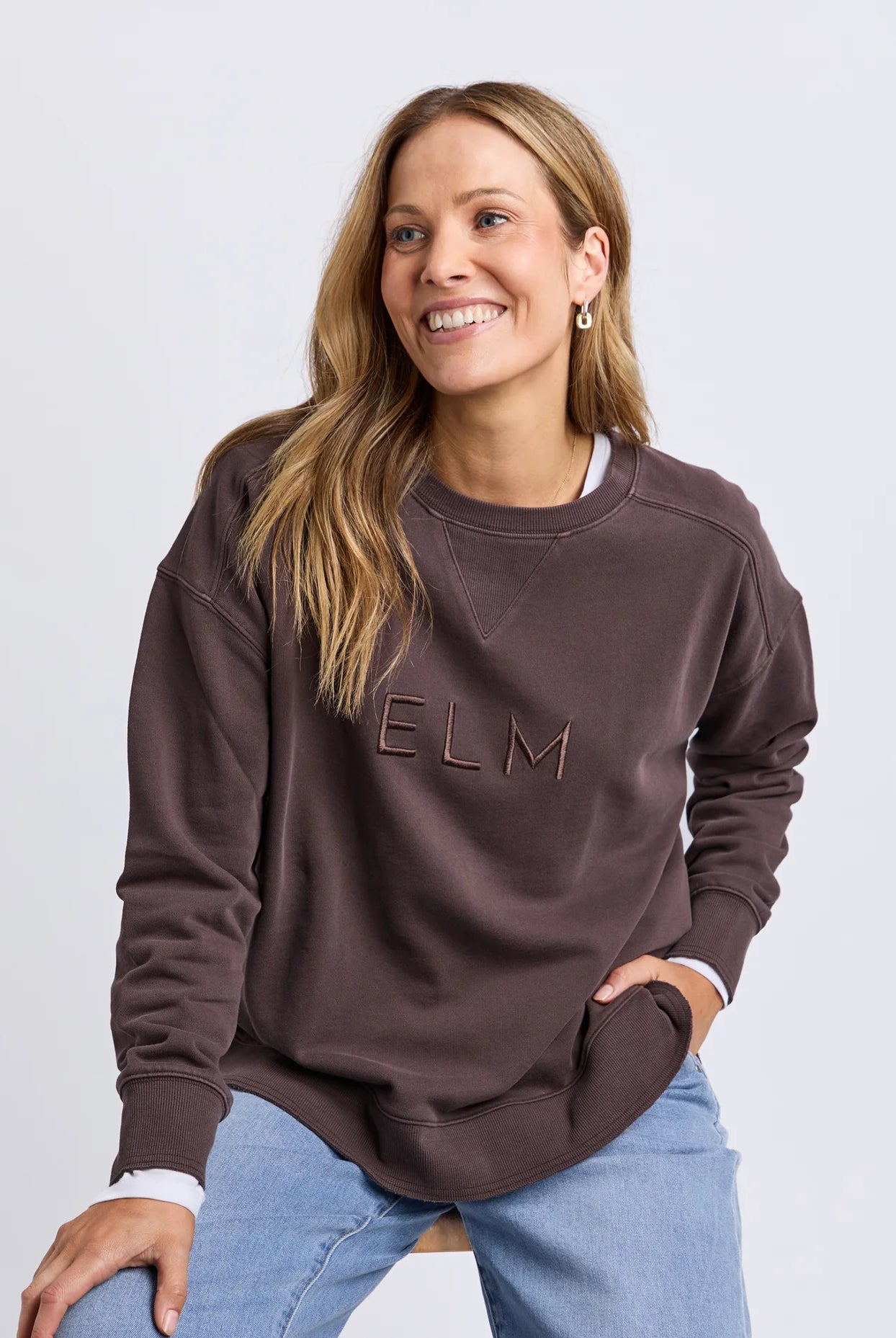 Established Crew in Coffee with chest embroidery, raw hem detail, scooped hemline and a relaxed fit in 100% cotton fleece.