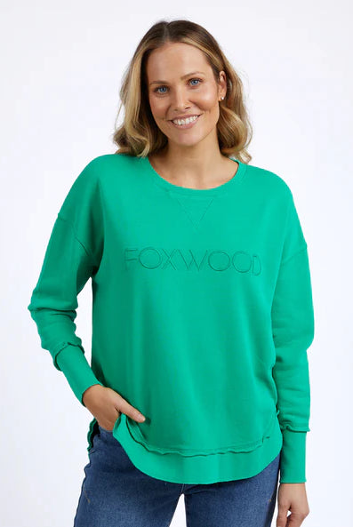 Foxwood Simplified Crew in bright green with round neck, raw edge details, and side splits for a relaxed, everyday look.