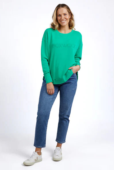 Foxwood Simplified Crew in bright green with round neck, raw edge details, and side splits for a relaxed, everyday look.
