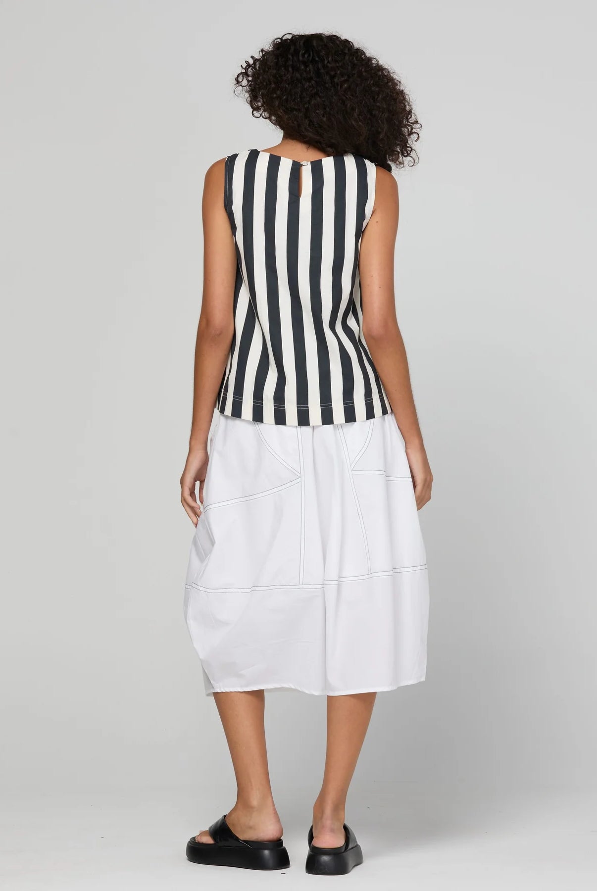Guru Skirt in Coconut featuring a 3/4 length, stretch drawstring waistband, front and back pockets, full lining and black contrast stitching.