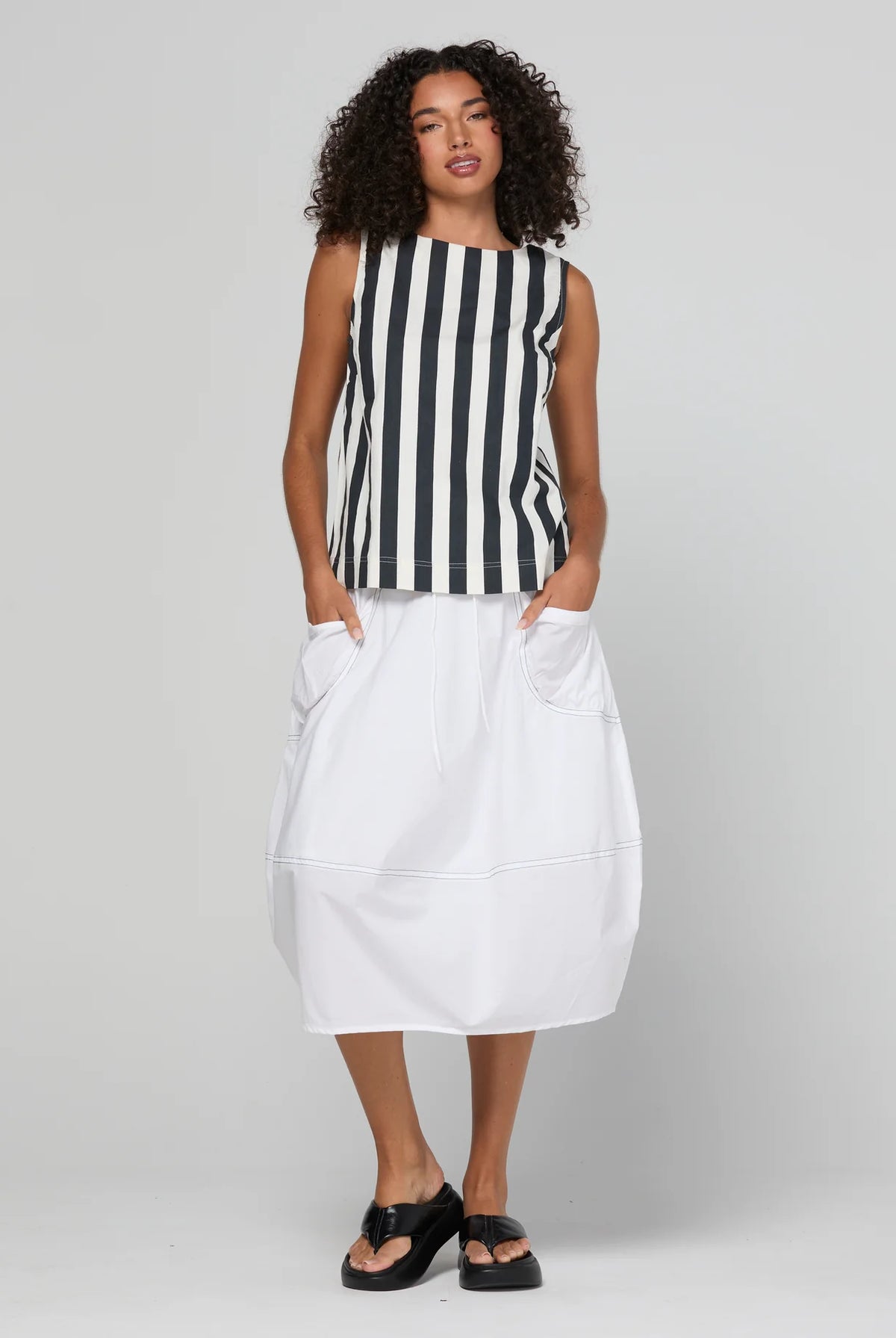 Guru Skirt in Coconut featuring a 3/4 length, stretch drawstring waistband, front and back pockets, full lining and black contrast stitching.