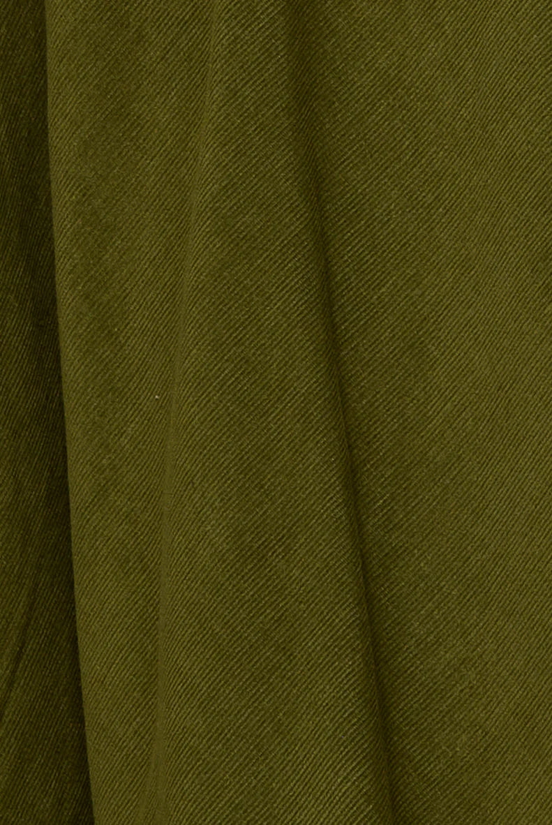 Woman wearing the Cord Guru Pant in Olive Green, featuring a relaxed 3/4 balloon-leg fit in soft cotton cord with a cool-toned khaki finish.